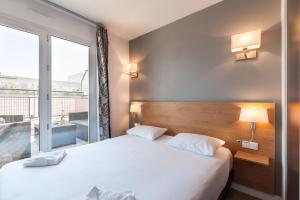 Ένα ή περισσότερα κρεβάτια σε δωμάτιο στο Residhotel Le Grand Prado
