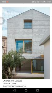 a house with a large window on the side of it at La casa di Mario...tra le case Via del Giglio 52 in Ortona