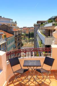 two chairs and a table on a balcony at Best Western Plus Hôtel Massena Nice in Nice