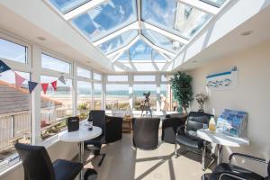 a room with windows and tables and chairs at The Penellen guest accommodation room only in Hayle