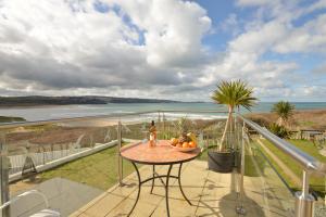 a table on a balcony with a view of the ocean at The Penellen guest accommodation room only in Hayle