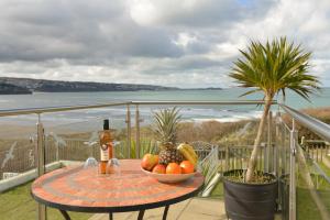 a table with a bowl of fruit on a balcony at The Penellen guest accommodation room only in Hayle