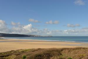 a sandy beach with the ocean in the background at The Penellen guest accommodation room only in Hayle