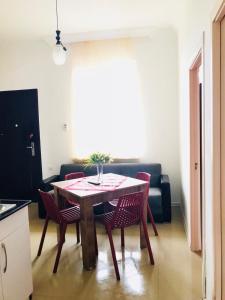 a table and chairs in a living room with a couch at BSG Rustaveli 184 in K'obulet'i