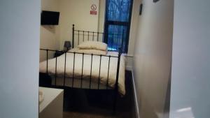 a small bedroom with a bed with white blankets at Kings arms hotel in Farnworth