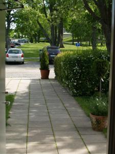 a sidewalk with cars parked in a parking lot at Hotel Laurenti in Söderköping