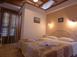 a bedroom with a bed with two towels on it at Odyssia near the Seaside in Aghios Petros Alonissos +144 photos