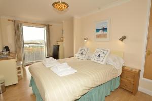 a bedroom with a bed with towels on it at The Penellen guest accommodation room only in Hayle