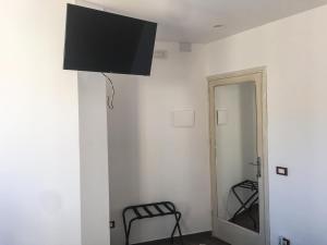 a room with a television hanging from a wall at Case Vacanza Calamaro in Trabia