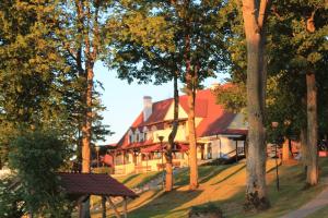 a large house in the middle of a forest at Domki w porcie Zielony Gaj in Mikołajki