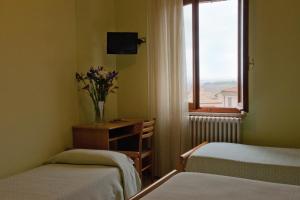 Tempat tidur dalam kamar di Hotel Centrale di Paolo e Cinzia