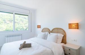 a bedroom with a white bed and a window at Gala Mar - Sa Riera / Begur Sea View in Begur +27 photos