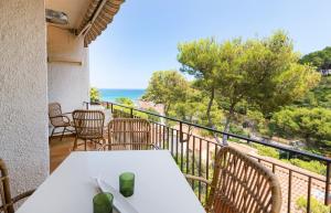 a balcony with a table and chairs and the ocean at Gala Mar - Sa Riera / Begur Sea View in Begur
