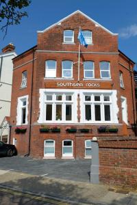 a red brick building with a southern rocks sign on it at Southsea Rocks Hotel in Portsmouth