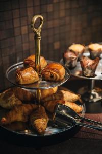 a tray of pastries and croissants on a table at Hotel Bagués, a Small Luxury Hotel of the World in Barcelona