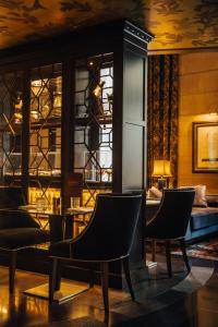 a room with chairs and a table and a bed at Hotel Bagués, a Small Luxury Hotel of the World in Barcelona