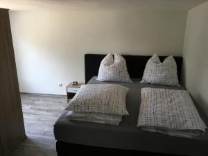 a bedroom with a bed with white pillows at Ferienhaus Seenland in Elsterheide