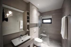 a bathroom with a toilet and a sink and a shower at Villa Amoretta - Pisak (Omiš) in Pisak +20 photos