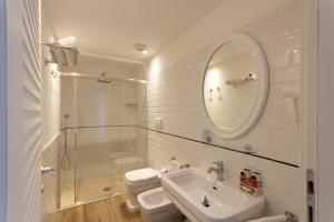 a bathroom with a shower and a sink and a mirror at Hotel Nautilus in Cagliari