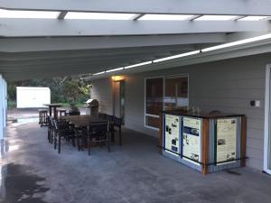 a patio with a table and chairs and a building at My Island Home in Kingscote