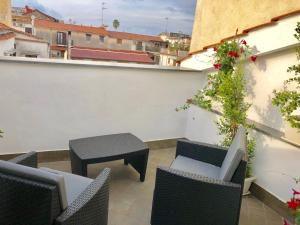 a patio with chairs and a table on a balcony at Sorrento Inn Funzionista in Sorrento