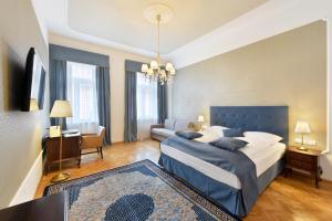 Palais-Hotel Erzherzog Johann في غراتس: غرفة نوم بها سرير كبير وأريكة