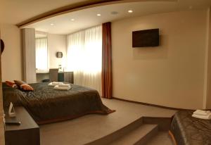 מיטה או מיטות בחדר ב-Garni Hotel Vigor - EV station