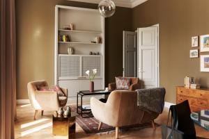 a living room with two chairs and a table at Hotel St. George Helsinki in Helsinki