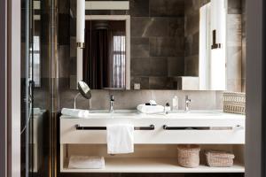 a bathroom with a sink and a mirror at Hotel St. George Helsinki in Helsinki