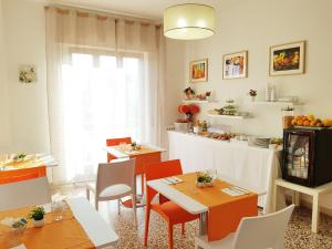 a dining room with tables and chairs and a window at Villa Susy Relais in Sant'Agnello
