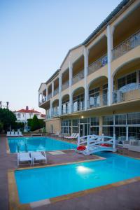 a hotel with a swimming pool and a building at Hotel Diamantidis in Myrina