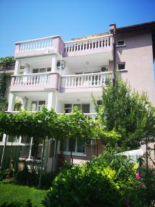 a white building with a balcony on top of it at Anele,Kiten in Kiten +15 photos