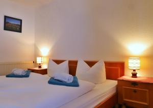 a bedroom with two white pillows on a bed at Pension Adler in Sonthofen