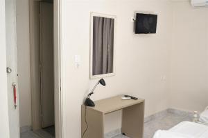a room with a desk with a lamp on it at Villa Fallias in Olympic Beach