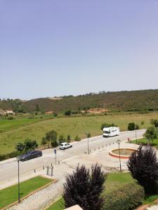 a street with cars parked on the side of a road at Sol Mar in Odeceixe