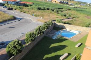 an external view of a house with a retaining wall and a swimming pool at Matosinhos -Seas Apartment- Cabo das Marés in Matosinhos