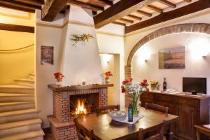 a living room with a table and a fireplace at Agriturismo Sanguineto in Acquaviva