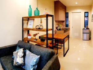 a living room with a couch and a table at Mailz Haven 7-2BR Apartment in Davao City