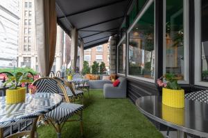 an outdoor patio with tables and chairs and windows at The Dwell Hotel, a Member of Design Hotels in Chattanooga