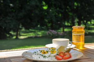 a plate of eggs and a cup of coffee on a table at Domek na wsi Mokosz in Kwilcz