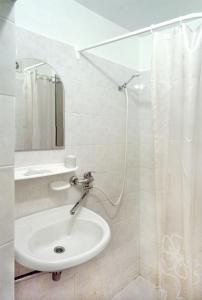 a bathroom with a sink and a shower at Motel Brencis in Iecava