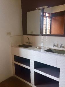 a bathroom with two sinks and a mirror at Amboseli Eco Camp in Amboseli
