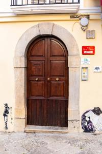 a large wooden door in the side of a building at b&b Casa Fusco in Fondi