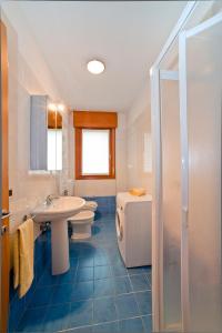 a bathroom with a sink and a toilet and a shower at Residence Roberta in Caorle