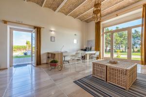 a living room with a table and a dining room at Agriturismo Masseria Cannella in Lesina
