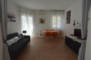 a living room with a couch and a table at Villa Norma in Milano Marittima