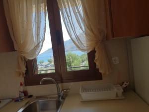 a kitchen counter with a sink and a window at Domaine Papakonstantis in Skoutari +127 photos