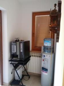 a room with a microwave and a refrigerator and a window at ABAGuesthouse in Sarajevo