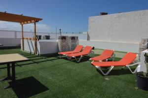 a patio with chairs and a table on a roof at Armonía Beach 17 in Arinaga