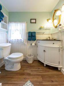 a bathroom with a white toilet and a sink at The Elmhurst Inn in Bar Harbor